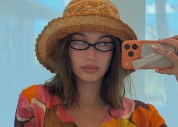 Hailey Bieber’s Sheer Bodysuit Photo Gets Risky With Unbuttoned Jeans