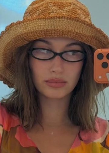 Hailey Bieber’s Sheer Bodysuit Photo Gets Risky With Unbuttoned Jeans